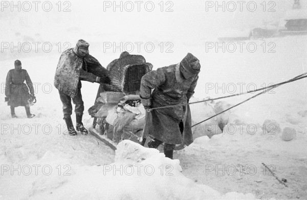 Reckingen: Military search-troupe pulling sleigh with belongings of avalanche victims. 1970