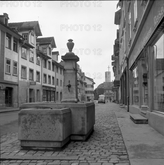 A Man and a woman sitting in front of a small shop in Splügen 1941