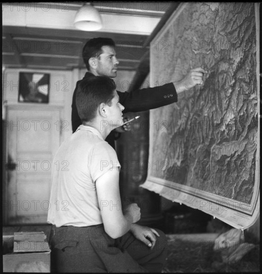 Polish internees look at a map of Switzerland; 1940