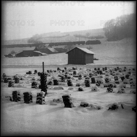 Stacked peat, covered in snow; 1957