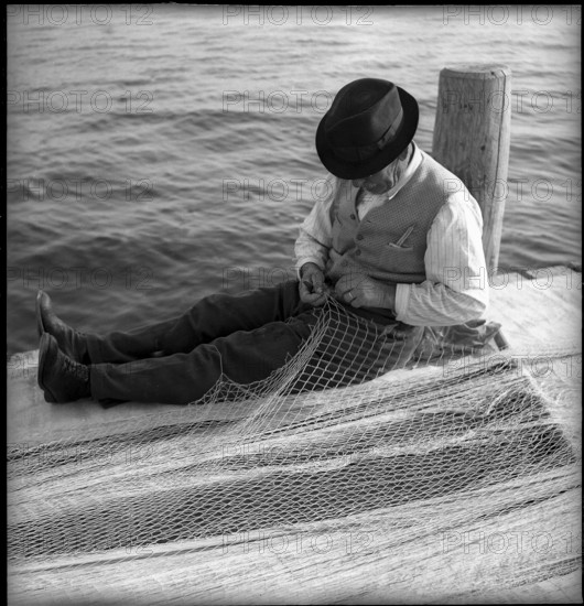 Fishermen mending nets on Lake Geneva, Ouchy 1945