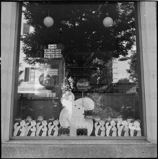 Product advertising, CocaCola advertising in shop windows; 1952