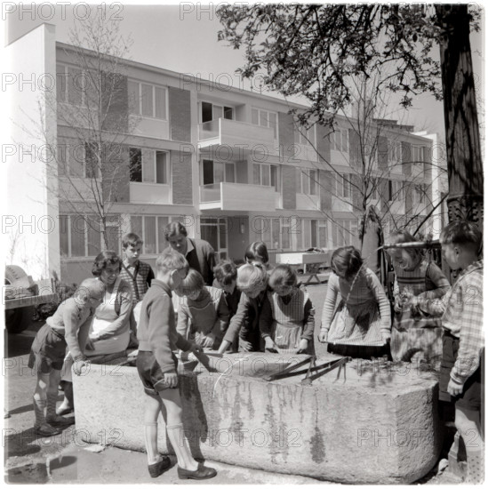 Children playing at trough