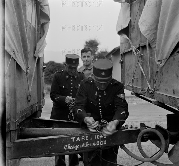 French customs officers seal Swiss trucks; 1944