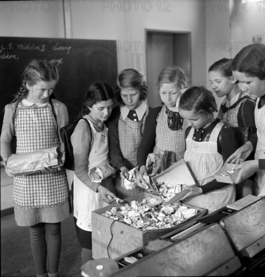 WW 2: economy of war; girls collecting tin tubes.