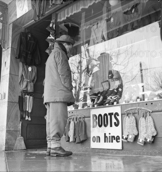Grindelwald, man looking at shop window; 1950.