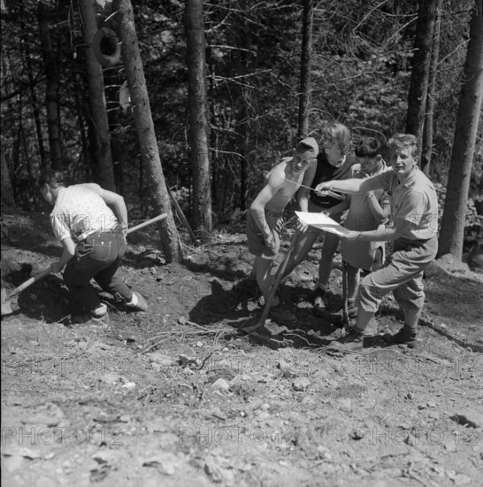 Isenfluh, volunteers building access road to mountain village; 1959.