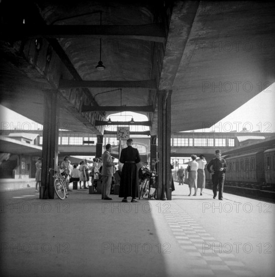Strike in the Alsace: Travellers waiting at station, 1953.