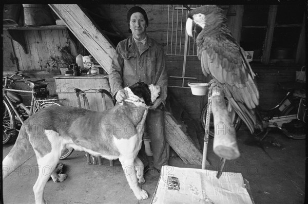 Man with dog and parrot in the Emmental, 1970.