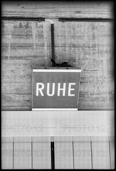 Breeding blackbird's nest on lamp with letters 'Ruhe' 1970.