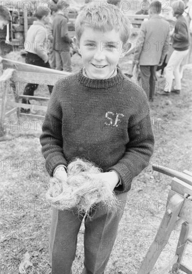 Braechete, in Zaeziwil, boy with a handful of flax, 1965.