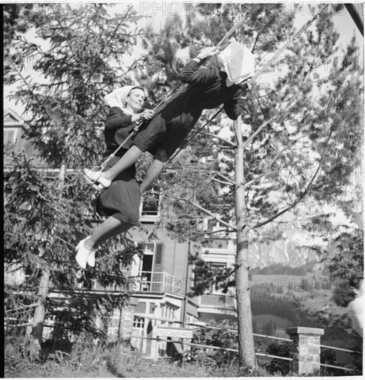 Young nurses swinging in the garden.