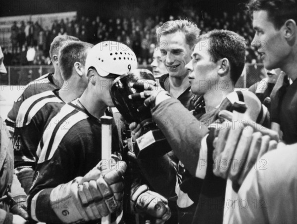 Swiss Ice hockey cup 1964/65: winner SC Bern, goalie Kiener passing cup to Schmidt.