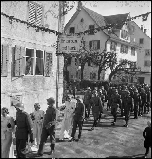 Soldiers' wedding; three wedding couples passing through village; 1941.