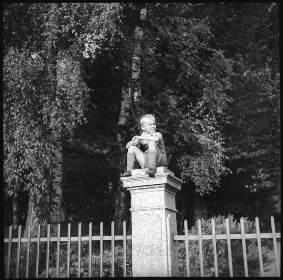 Boy sitting on a pillar, 1939.