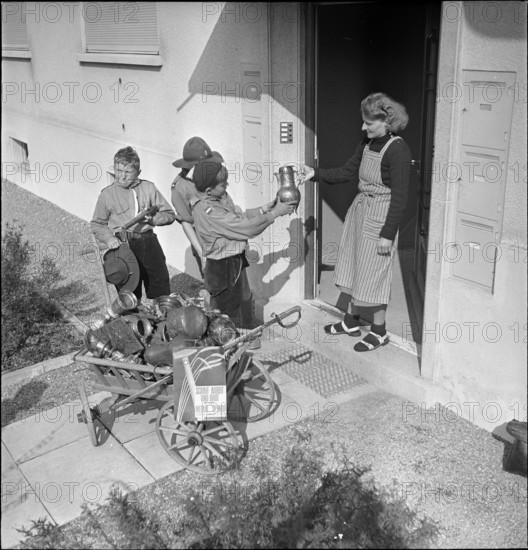 Boys collecting articles of non-ferrous metal; 1940.