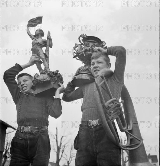 Boys collecting articles of non-ferrous metal; 1940.