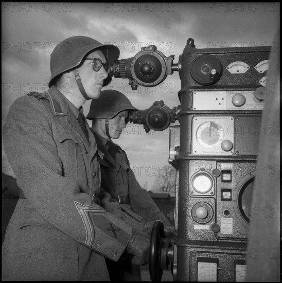 Soldiers at controls for anti aircraft guided arm, Berne 1951.