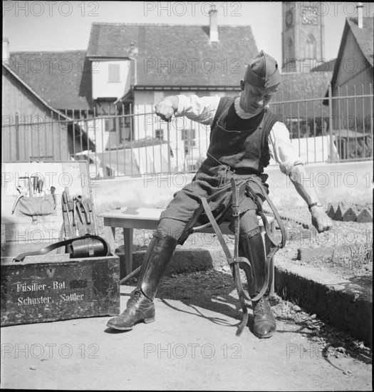 WW 2: soldier sewing, stitching horse harness, 1940.
