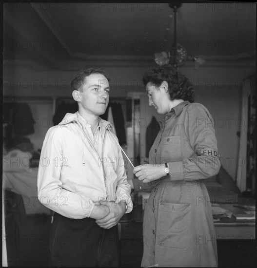 Refugee trying clothes on, 1945.