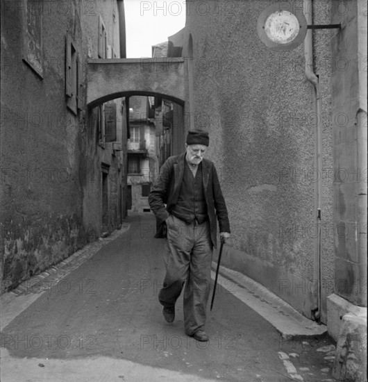 Grandvaux: old man using walking stick; 1948.