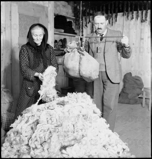 Man and woman weighing wool, 1945.