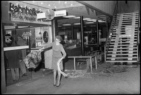 Bomb attack in Zurich mainstation; woman shaking out broken pieces of her clothes 1971.