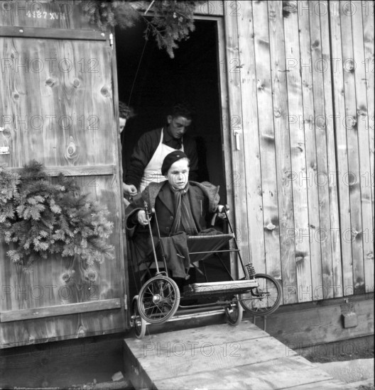 Disabled boy in wheelchair, 1945.