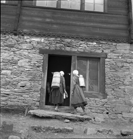 Lötschental, women carrying milk churn, 1941.