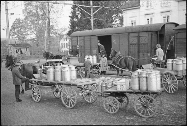Milk cans; loading in goods train; 1941.