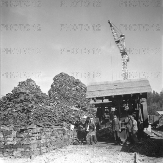 German internees working in Von Roll's scrap metal warehouse; 1945.