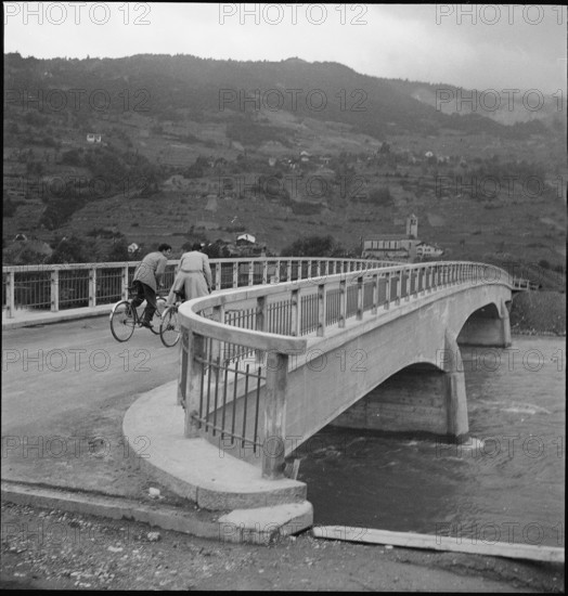 Bikers on the new ferroconcrete bridge across the Rhone river near Noes 1949.