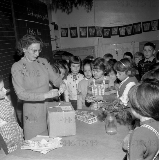 Teacher cording a parcel for children in Hungary, Zurich 1956.