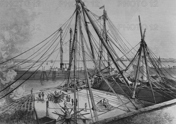 Havana, Cuba. The new Machina at the San Fernando dock. On 21 November 1882, work was carried out to install the structure, of English construction, under the direction of the first boatswain of the Spanish Navy, Mr. Antonio Menjibar. It was a crane-tower used for the placement of masts and different rigging on ships. The dock was occupied by dependencies of the Spanish Navy. Engraving by Tomas Carlos Capuz. La Ilustracion Espanola y Americana (The Spanish and American Illustration), 1883.