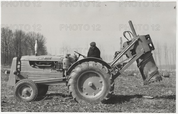 A machine tractor equipped with a special hydraulic tool to remove stumps from the ground