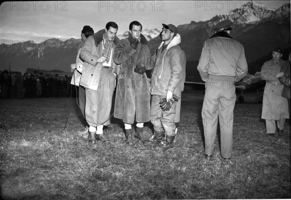 Rescued Dakota passengers at Unterbach military airfield, reporter interviews passenger; 1946.