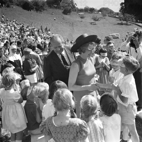 The Prince and his wife surrounded by children.