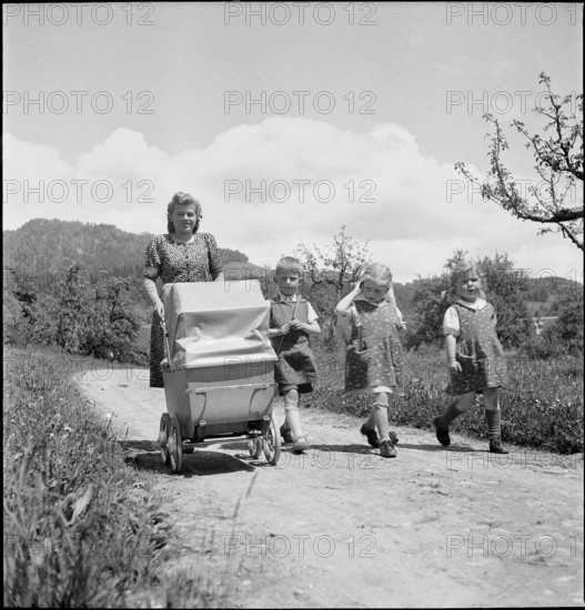 Mother and children walking, 1941.