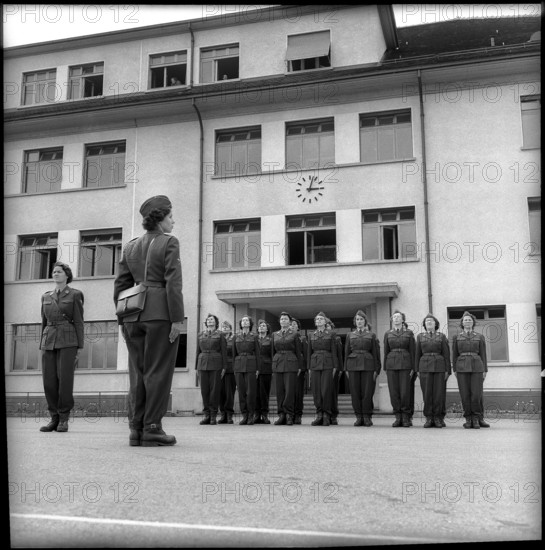 Women soldiers drilling in front of barracks Fribourg 1962.