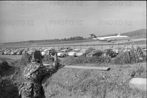 Soldier in surveillance trench, Zurich airport 1970.