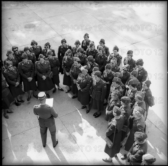 Women soldiers listening to officer speaking, Zurich 1962.
