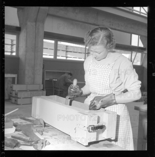 worker fills asbestos cement in a window box form.