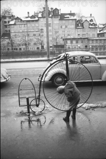 Man mending high wheel in Zurich, 1965.