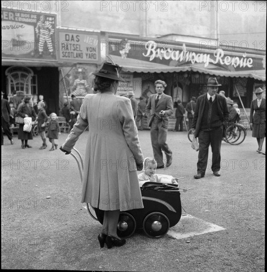 Woman strolling with a pram; 1942.