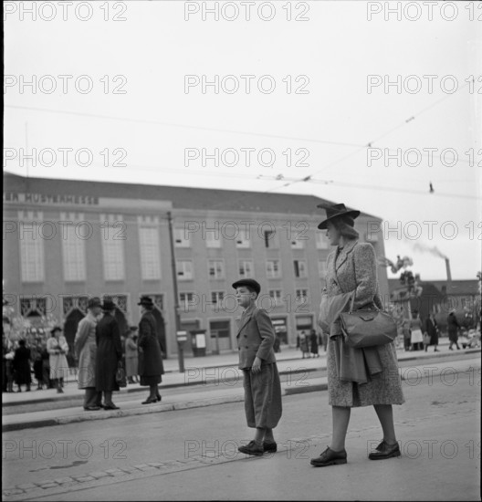 Woman and child strolling before exhibition hall; 1942.