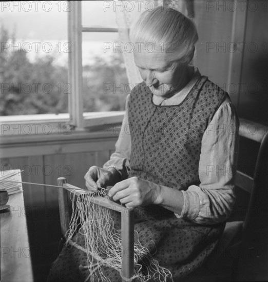 Woman braiding straw, 1940.