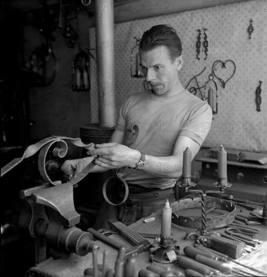 Geneva: artist blacksmith in his studio; 1943.