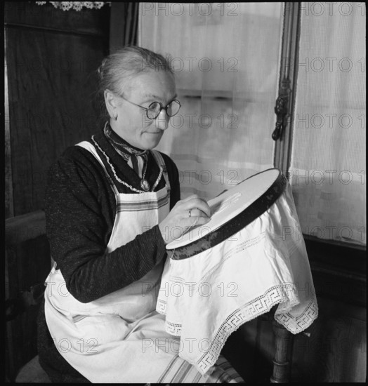 Home embroideress at work, 1942.