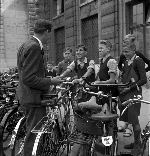 Basle, boys offer cleaning of bicycles; 1941.