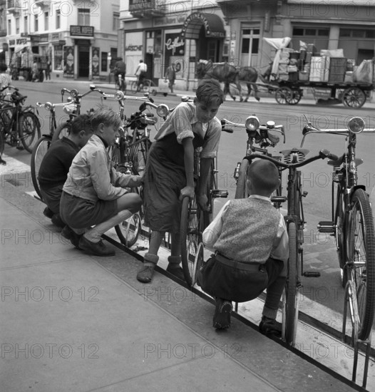 Basle, boys cleaning bicycles; 1941.